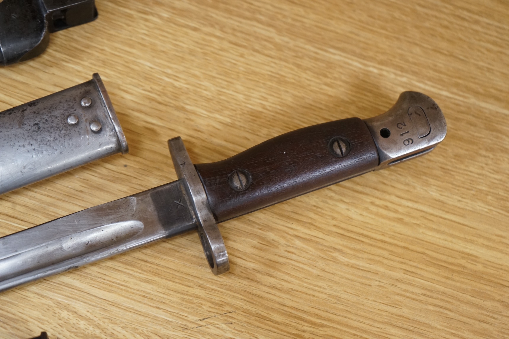 A 1907 bayonet by Wilkinson in its steel mounted leather scabbard, another similar with leather frog, two small British bayonets, a Continental bayonet, and two assorted hunting knives (7)
